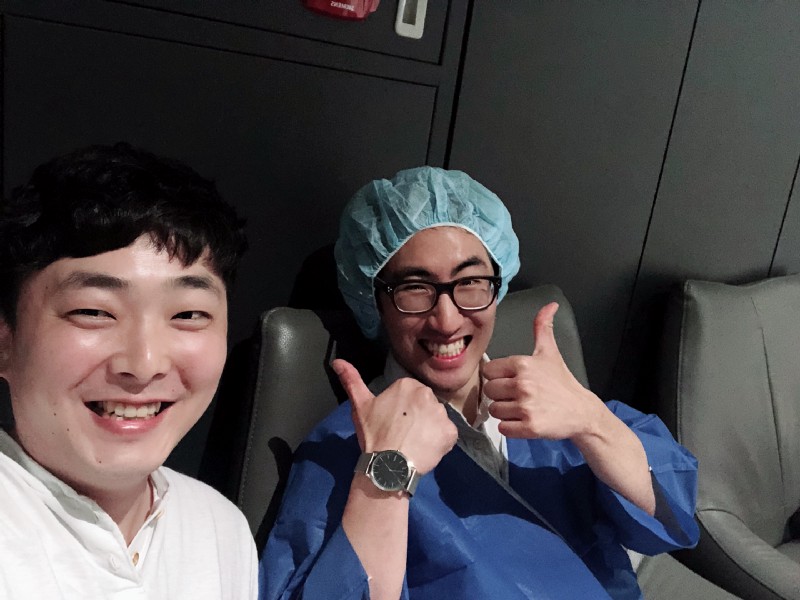 Two men smiling while waiting for SMILE eye surgery in Korea