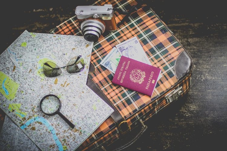 suitcase luggage with map, sunglasses, passport and money for trip to korea